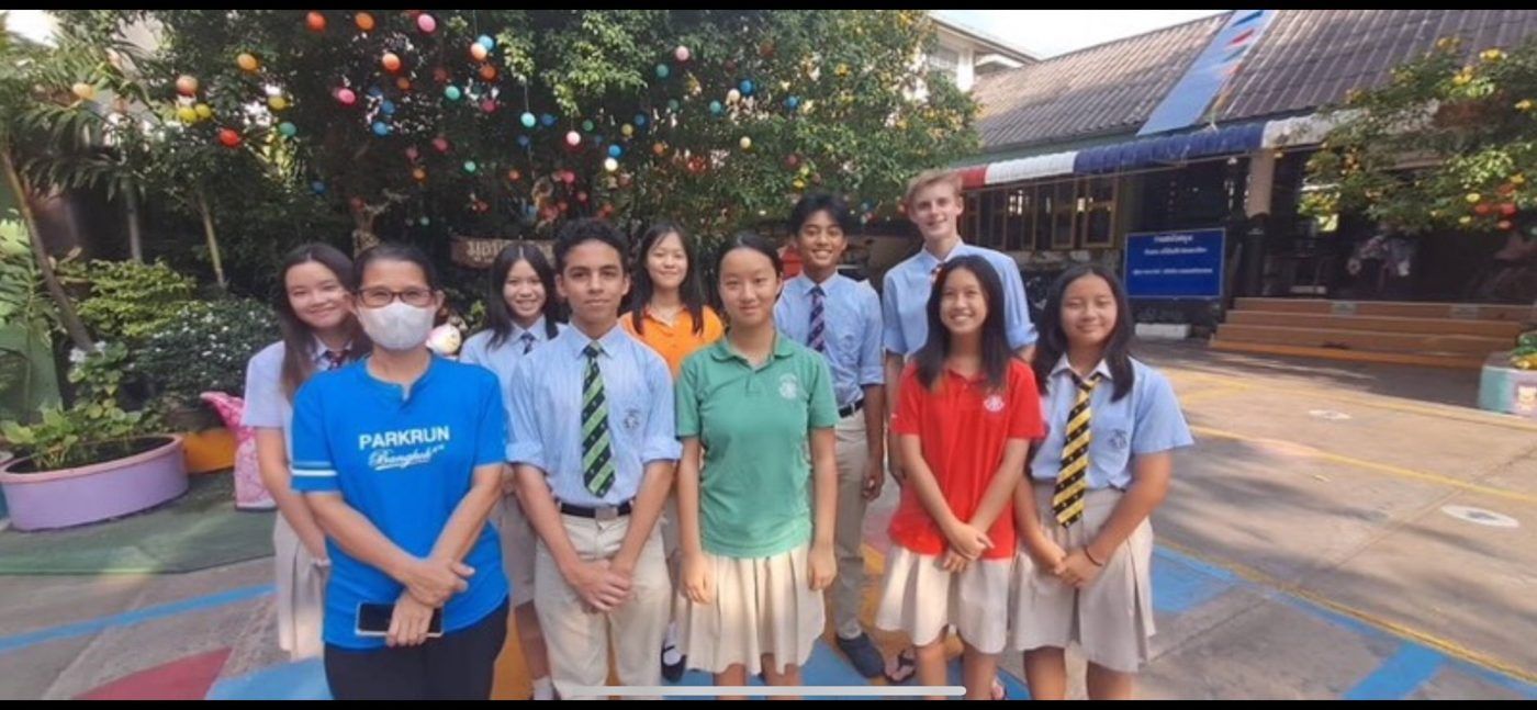 Harrow students with charity partners outdoors