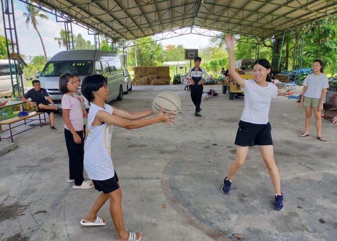 Playing basketball with children from a partner charity
