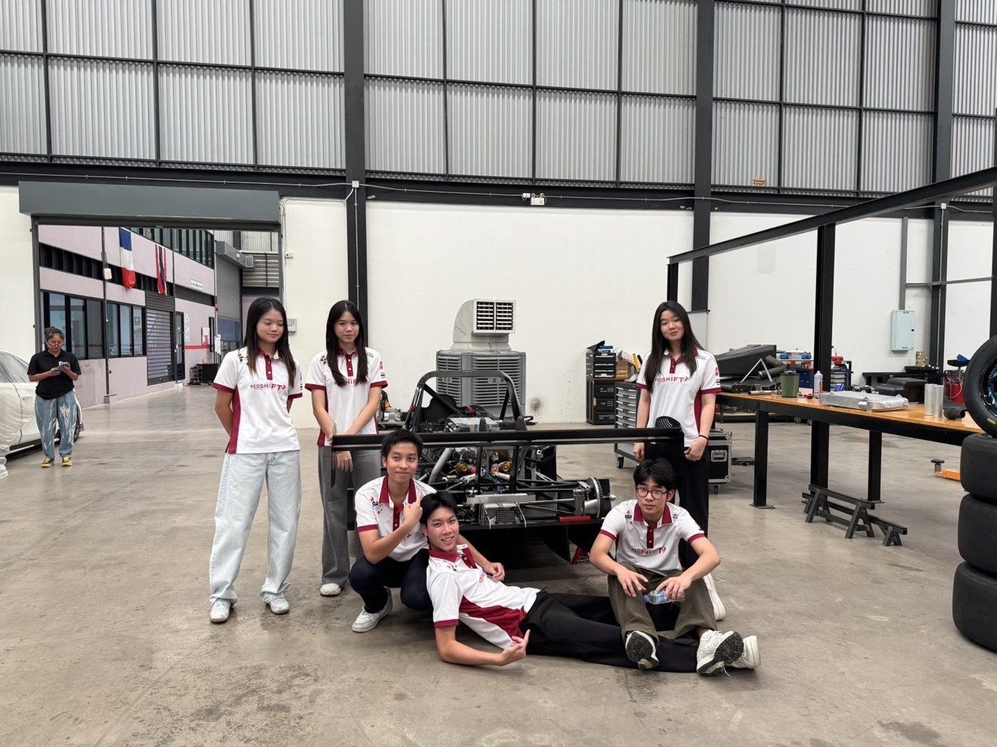 Team visiting a race car workshop